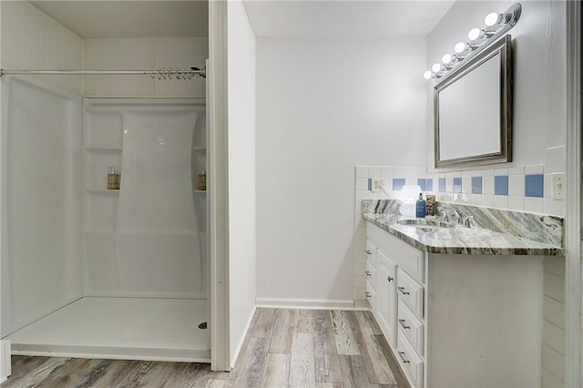 122 Vickery Dr, Fairburn, GA 30213 - bathroom featuring wood finished floors, vanity, a shower, and tasteful backsplash