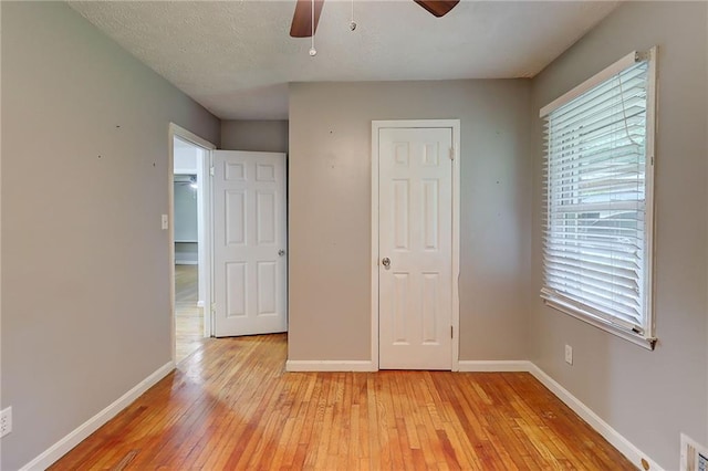 122 Vickery Dr, Fairburn, GA 30213 - unfurnished bedroom with light wood-style flooring, baseboards, and multiple windows