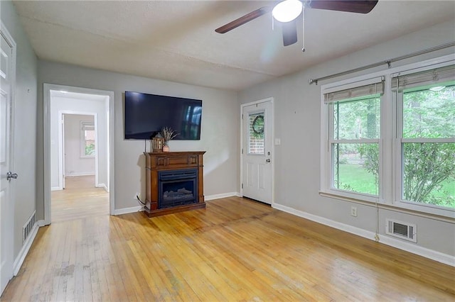 122 Vickery Dr, Fairburn, GA 30213 - foyer with light wood finished floors, ceiling fan, a fireplace, and baseboards