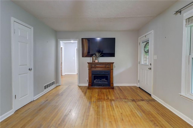 122 Vickery Dr, Fairburn, GA 30213 - unfurnished living room with light wood-type flooring, a fireplace, and baseboards