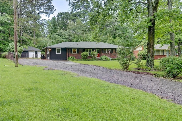 122 Vickery Dr, Fairburn, GA 30213 - ranch-style home with a front lawn and view of wooded area