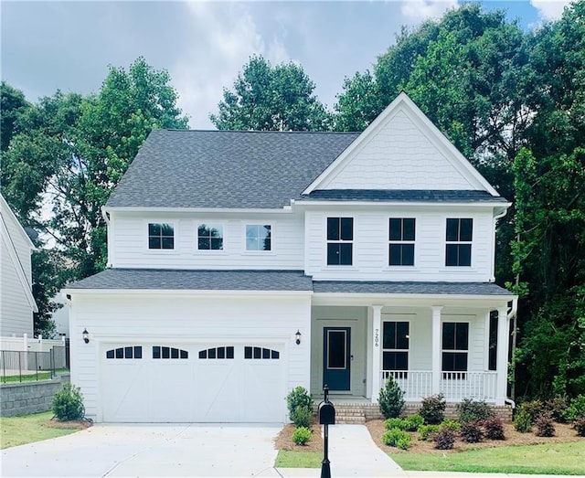 7206 Grand Reunion Dr, Hoschton, GA 30548 - view of front of house featuring covered porch, a garage, driveway, and roof with shingles