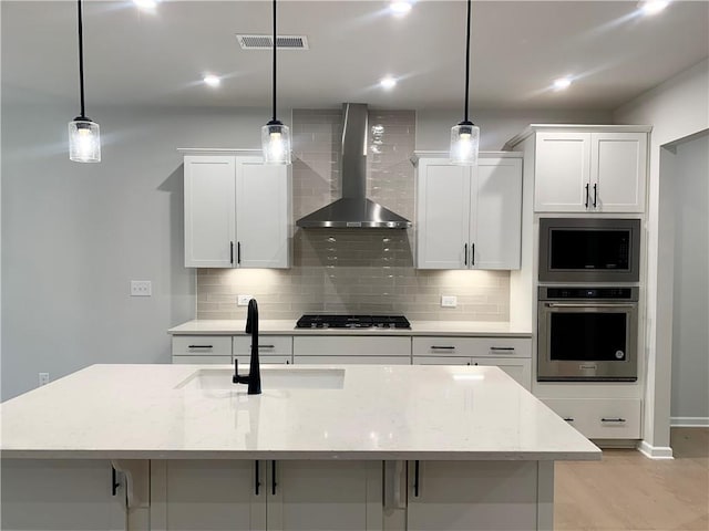 7206 Grand Reunion Dr, Hoschton, GA 30548 - kitchen featuring stainless steel appliances, wall chimney exhaust hood, tasteful backsplash, white cabinets, and recessed lighting