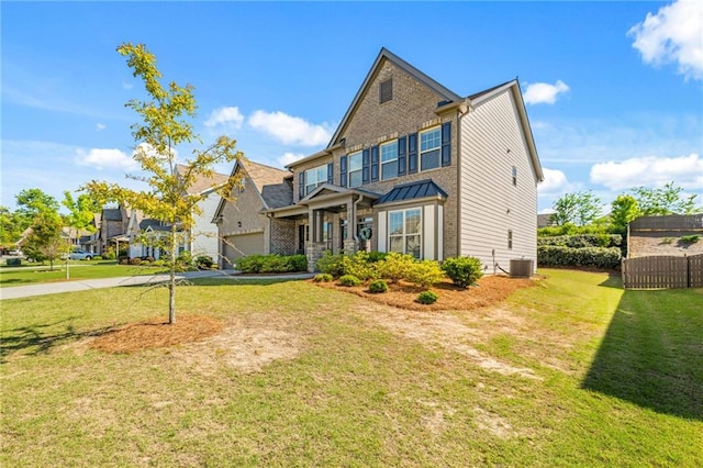 craftsman-style home with central AC, a front lawn, and a garage