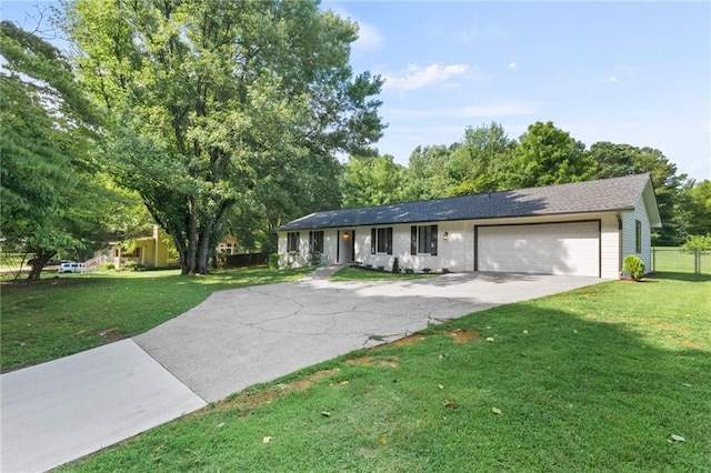 ranch-style home featuring a garage and a front lawn