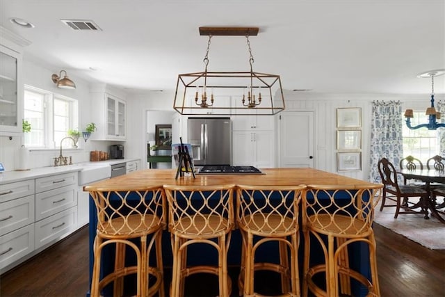 302 Chinquapin Dr SW, Marietta, GA 30064 - kitchen featuring a chandelier, appliances with stainless steel finishes, dark wood-style floors, a center island, and ornamental molding