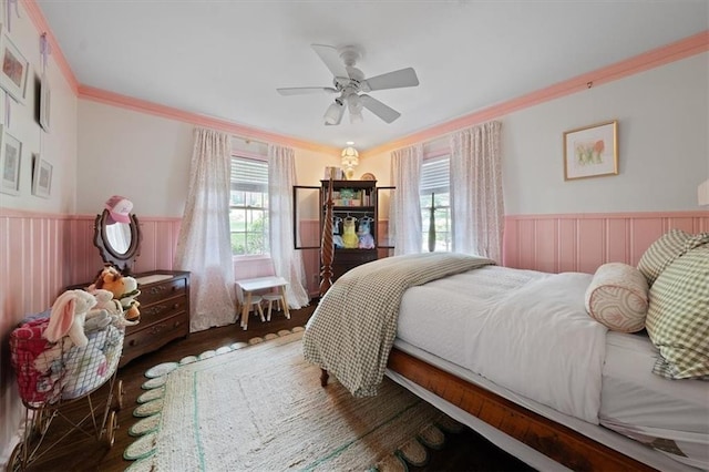 302 Chinquapin Dr SW, Marietta, GA 30064 - bedroom featuring wainscoting, multiple windows, wood finished floors, ornamental molding, and a ceiling fan