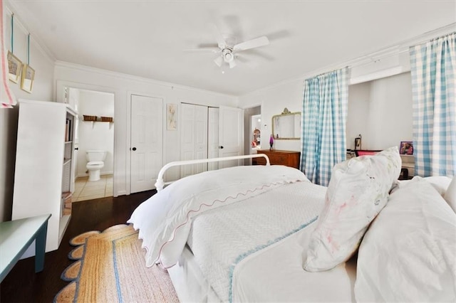 302 Chinquapin Dr SW, Marietta, GA 30064 - bedroom with crown molding, wood finished floors, multiple closets, ensuite bathroom, and ceiling fan
