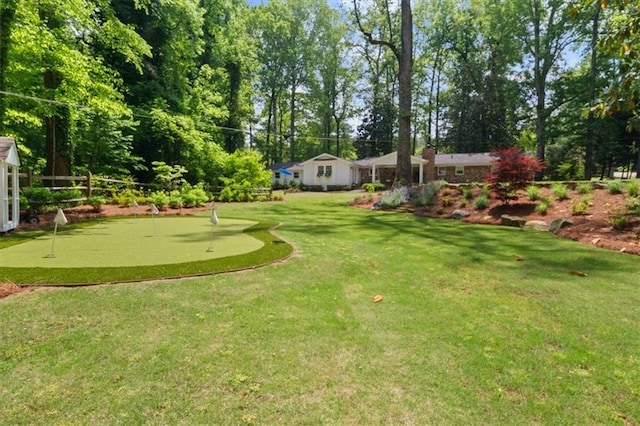 302 Chinquapin Dr SW, Marietta, GA 30064 - view of yard featuring an area to practice putting and view of wooded area