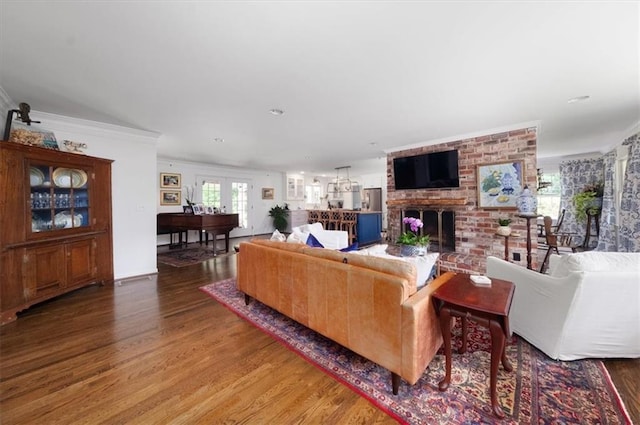 302 Chinquapin Dr SW, Marietta, GA 30064 - living area featuring wood finished floors, a brick fireplace, and ornamental molding