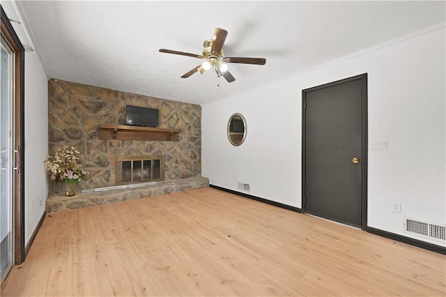 unfurnished living room featuring a fireplace, wood finished floors, and visible vents