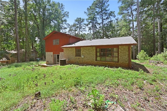 rear view of property with brick siding