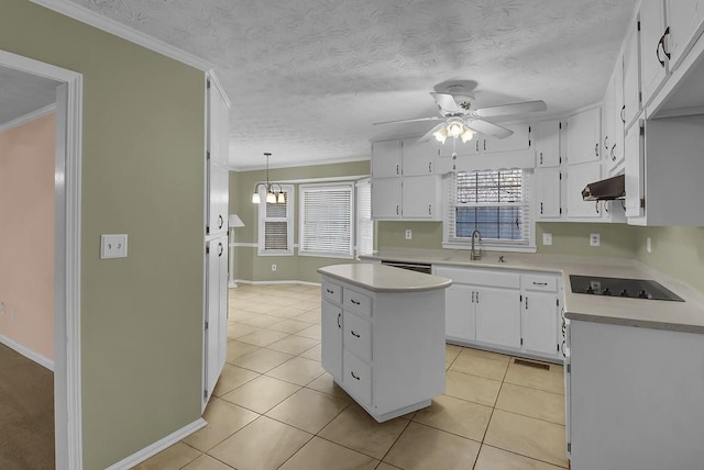 kitchen featuring white cabinetry, a center island, hanging light fixtures, black electric cooktop, and ceiling fan