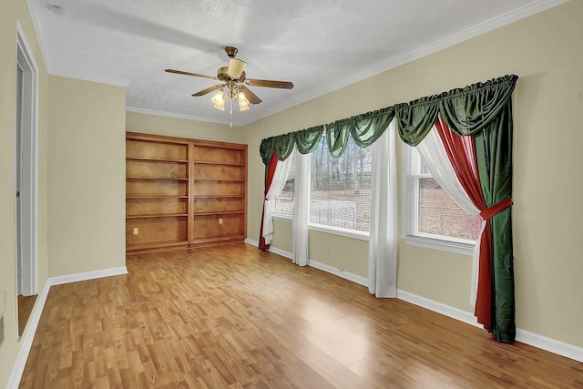 unfurnished room featuring crown molding, light hardwood / wood-style floors, and a wealth of natural light