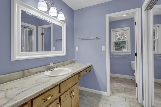 bathroom featuring vanity, tile patterned floors, and toilet