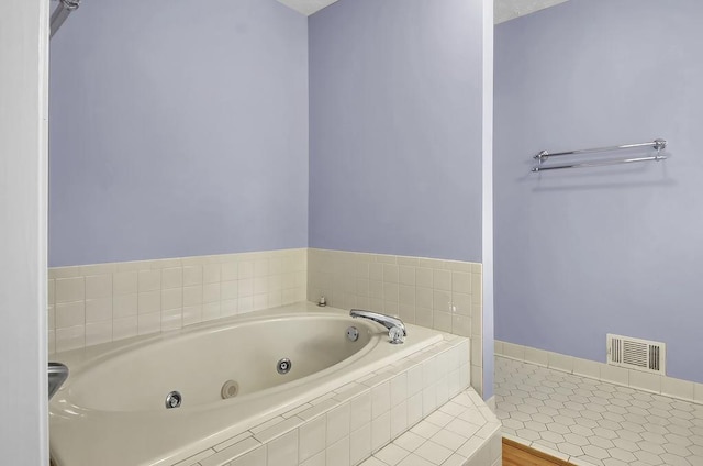 bathroom featuring tiled bath and tile patterned floors