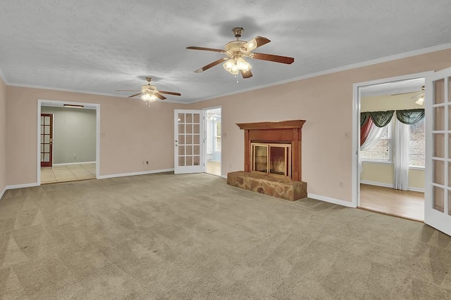 unfurnished living room with french doors, crown molding, light carpet, and a textured ceiling