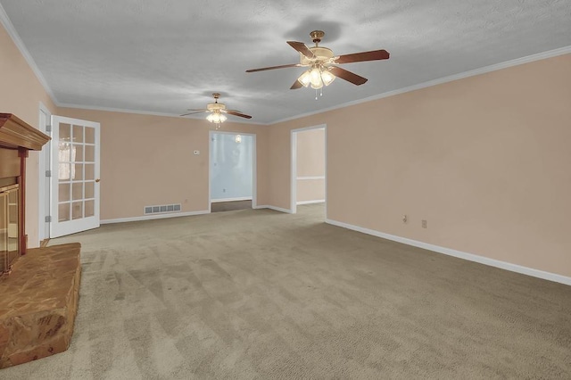 unfurnished living room with crown molding, a fireplace, and light colored carpet