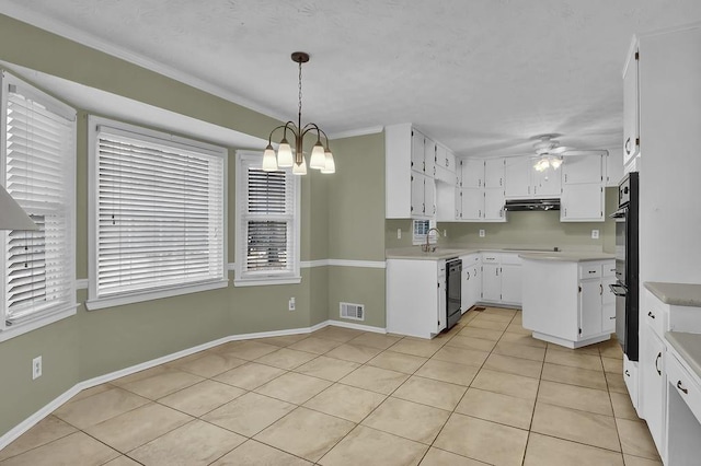 kitchen featuring pendant lighting, sink, white cabinetry, black appliances, and ceiling fan with notable chandelier