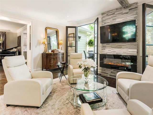 living room featuring light hardwood / wood-style floors, ornamental molding, and a tile fireplace