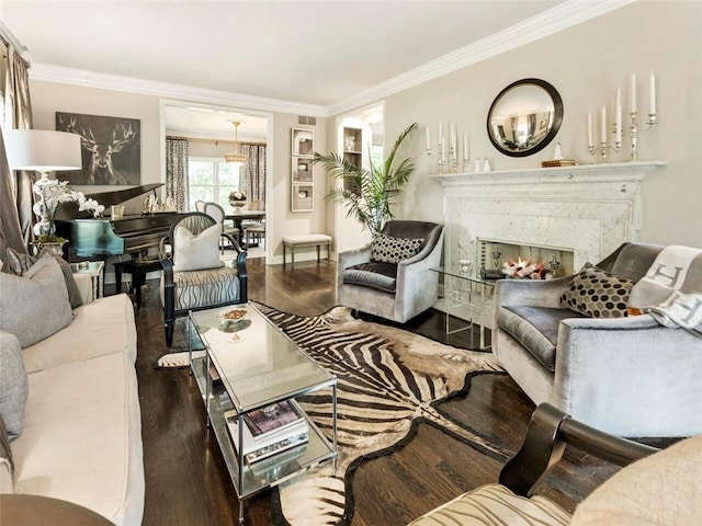 living room with dark hardwood / wood-style flooring, a premium fireplace, and crown molding