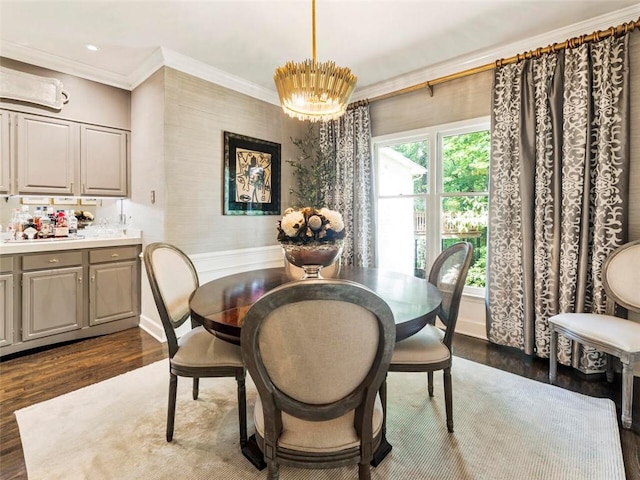 dining area with crown molding, dark wood-type flooring, and an inviting chandelier