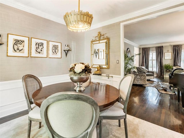 dining area featuring crown molding, hardwood / wood-style floors, and a notable chandelier