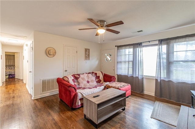 living room with dark hardwood / wood-style floors and ceiling fan