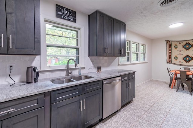 kitchen featuring dishwasher, a wealth of natural light, sink, and tasteful backsplash