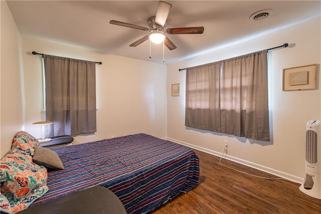 bedroom with ceiling fan and dark hardwood / wood-style floors