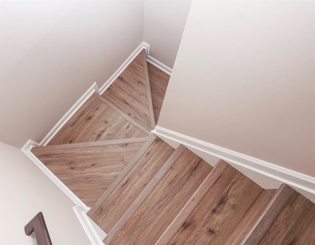 stairs with hardwood / wood-style floors