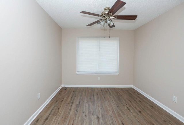 unfurnished room featuring ceiling fan, wood-type flooring, and a textured ceiling