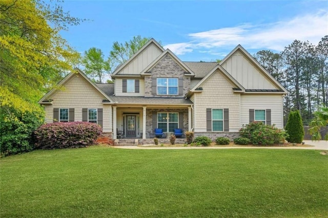 229 Primstone Way, Mcdonough, GA 30253 - craftsman-style house featuring board and batten siding, covered porch, a front lawn, and stone siding
