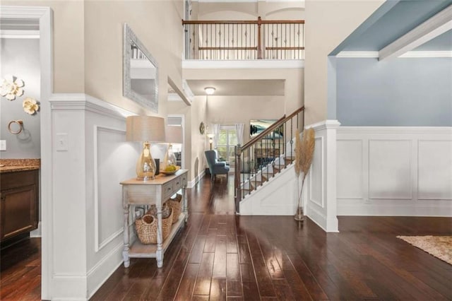 229 Primstone Way, Mcdonough, GA 30253 - entryway featuring a decorative wall, dark wood-style floors, stairs, wainscoting, and a high ceiling