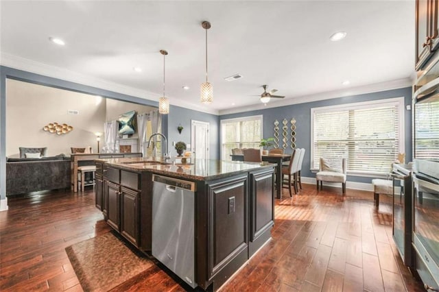 229 Primstone Way, Mcdonough, GA 30253 - kitchen featuring stainless steel dishwasher, a sink, open floor plan, dark stone counters, and plenty of natural light