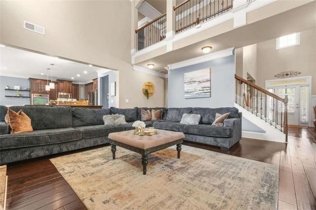 229 Primstone Way, Mcdonough, GA 30253 - living room with a high ceiling, hardwood / wood-style flooring, stairway, and crown molding