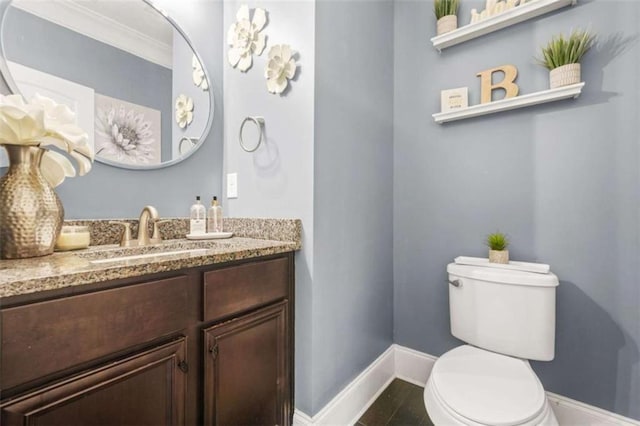 229 Primstone Way, Mcdonough, GA 30253 - bathroom with baseboards, toilet, vanity, and ornamental molding
