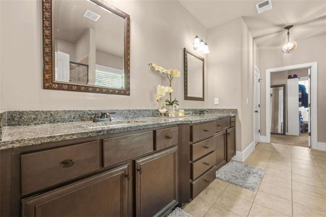 229 Primstone Way, Mcdonough, GA 30253 - bathroom featuring double vanity, tile patterned floors, baseboards, and a shower