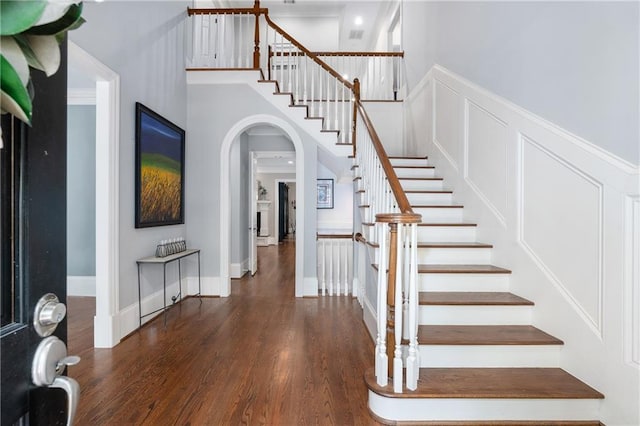 8643 Ellard Dr, Alpharetta, GA 30022 - foyer entrance featuring wood finished floors, arched walkways, and stairs
