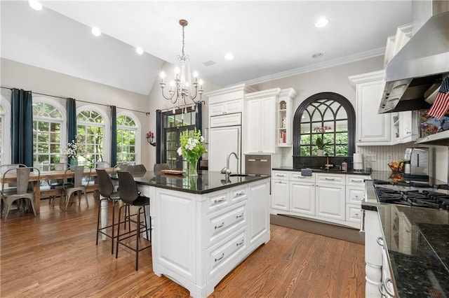 8643 Ellard Dr, Alpharetta, GA 30022 - kitchen featuring wall chimney exhaust hood, open shelves, a chandelier, white cabinets, and vaulted ceiling