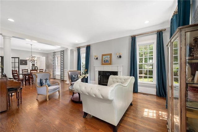 8643 Ellard Dr, Alpharetta, GA 30022 - living room with crown molding, a chandelier, wood finished floors, a premium fireplace, and recessed lighting