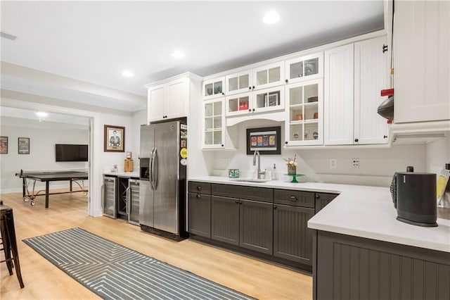 8643 Ellard Dr, Alpharetta, GA 30022 - kitchen with stainless steel fridge, white cabinets, light countertops, light wood-type flooring, and beverage cooler