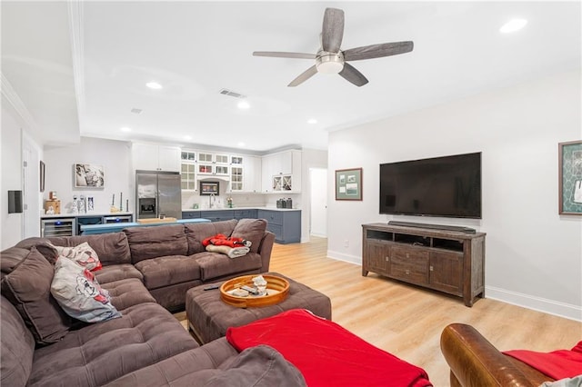 8643 Ellard Dr, Alpharetta, GA 30022 - living room with beverage cooler, light wood-type flooring, ceiling fan, ornamental molding, and recessed lighting