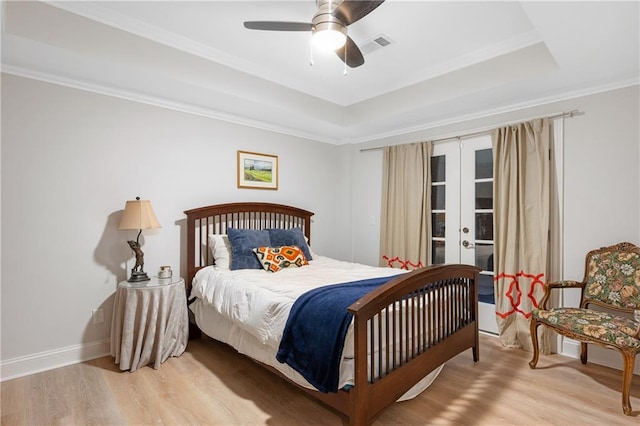 8643 Ellard Dr, Alpharetta, GA 30022 - bedroom with french doors, wood finished floors, a tray ceiling, a ceiling fan, and crown molding