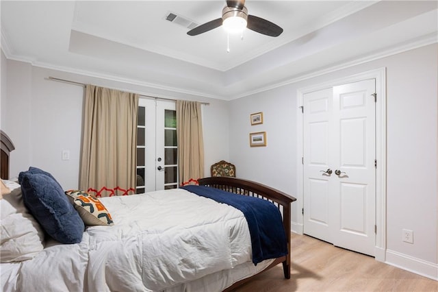 8643 Ellard Dr, Alpharetta, GA 30022 - bedroom featuring french doors, light wood finished floors, a raised ceiling, crown molding, and a ceiling fan