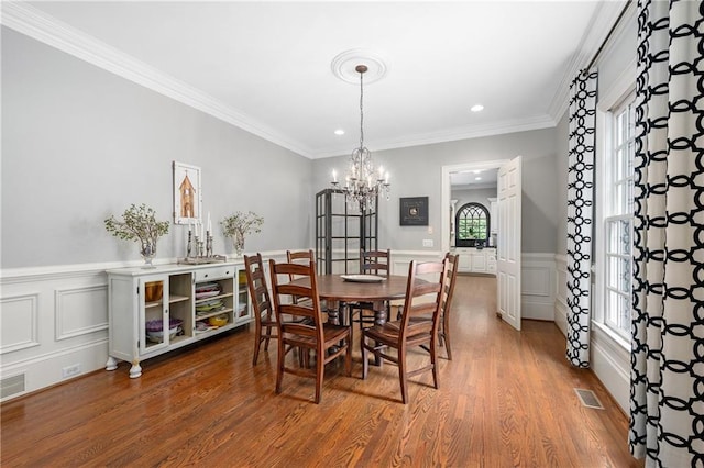 8643 Ellard Dr, Alpharetta, GA 30022 - dining area featuring a chandelier, wood finished floors, healthy amount of natural light, crown molding, and recessed lighting