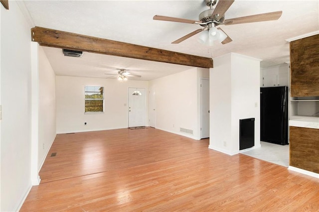 40 Kingston Dr, Comer, GA 30629 - unfurnished living room with ceiling fan, baseboards, beam ceiling, and light wood-style floors