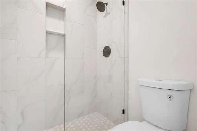 full bathroom featuring toilet and a stall shower
