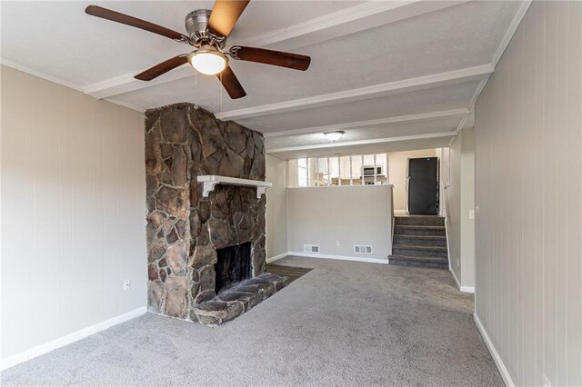 unfurnished living room with carpet, a fireplace, ornamental molding, and ceiling fan