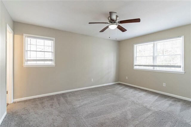 carpeted empty room featuring ceiling fan